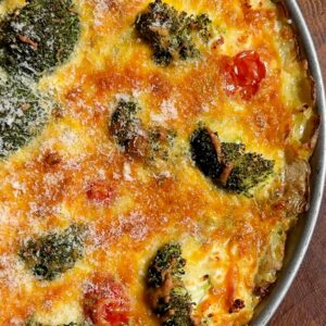 Cheesy potato crust quiche served warm in a baking dish