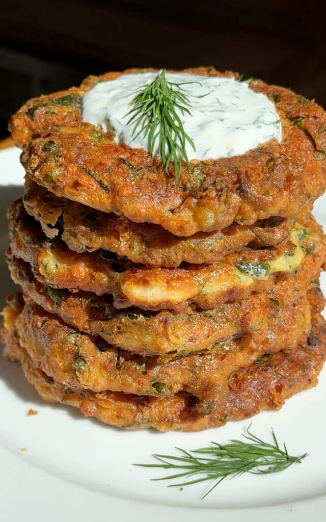 Crispy zucchini fritters with spinach, feta, and dill served with a side of Greek yogurt.