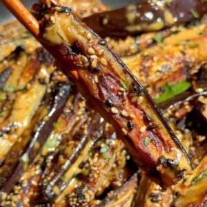 Crispy miso-Parmesan eggplant sticks served on a plate, golden brown and perfectly roasted.
