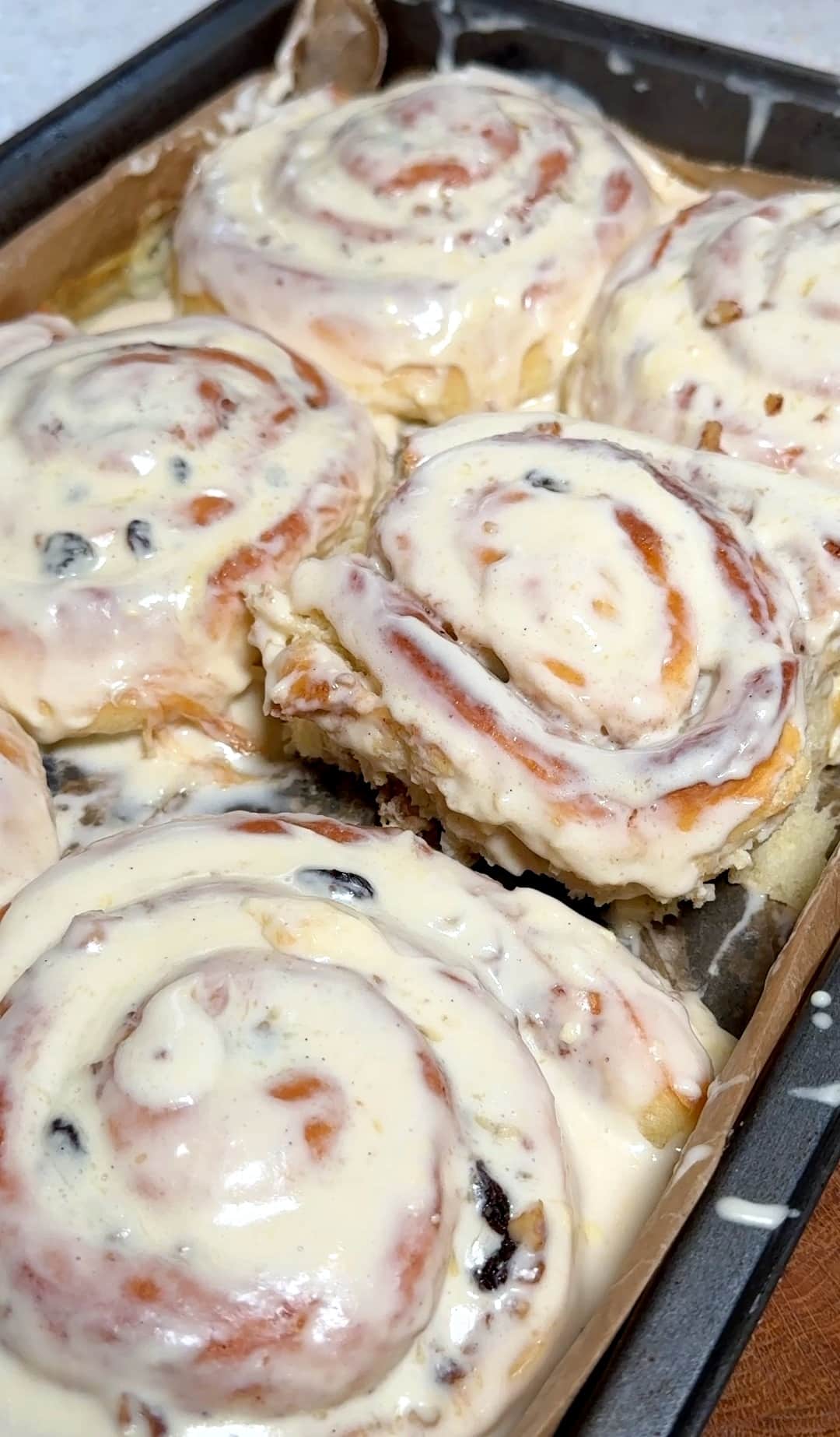 A baking tray with a freshly baked walnut cinnamon roll, golden brown and ready to enjoy.